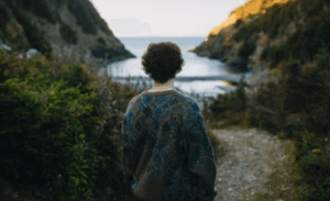 Person standing calmly in nature looking outward, symbolizing the grounding effect of EMDR and somatic psychotherapy for trauma and anxiety